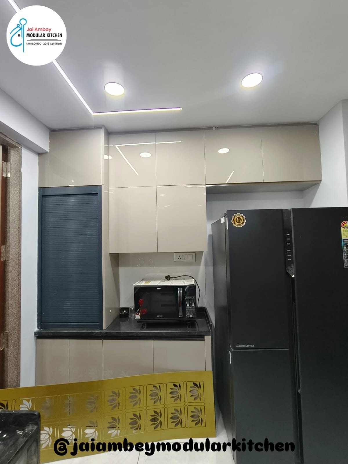 Beige gloss modular kitchen with roller shutter unit