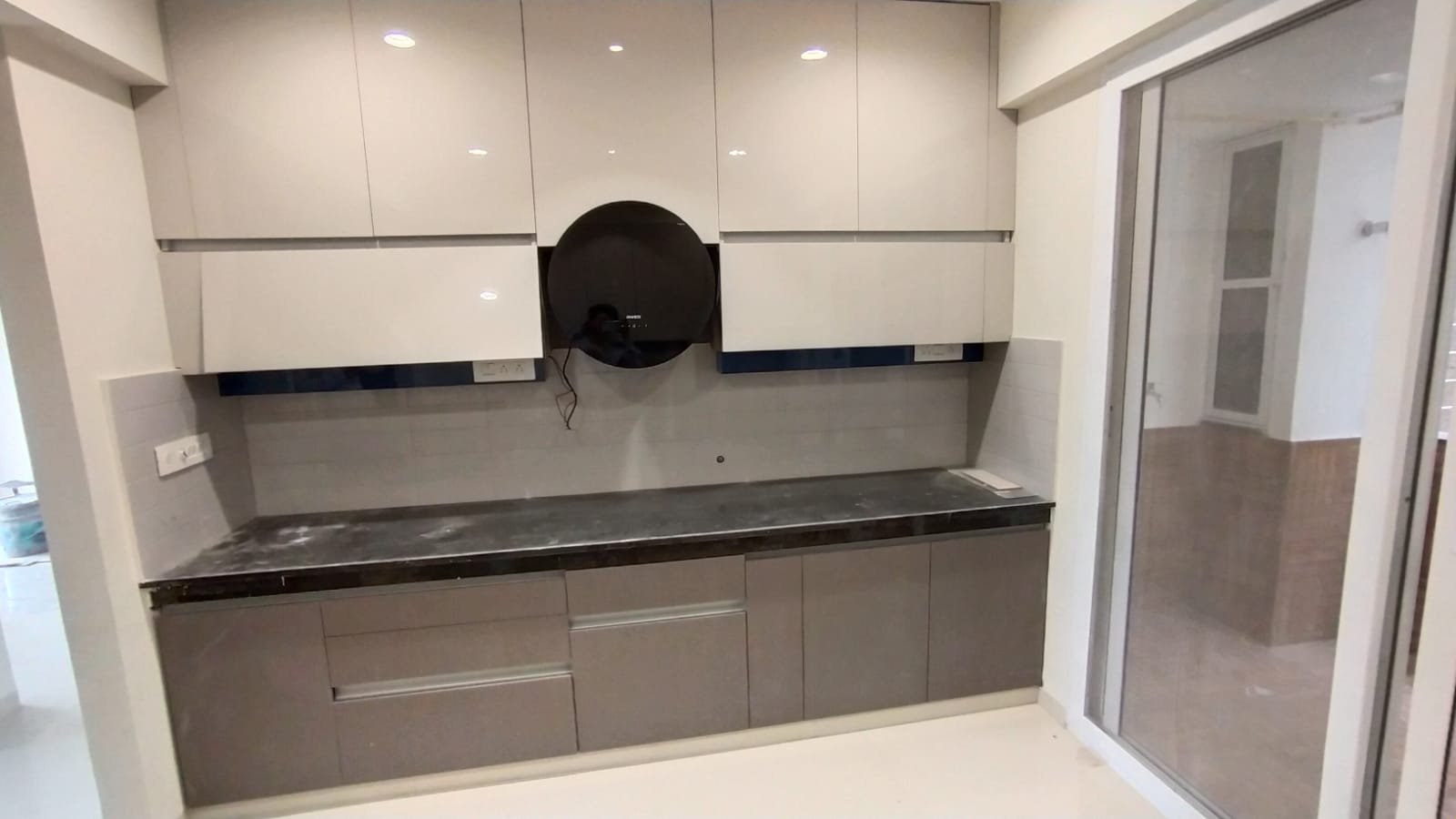 Newly installed white and grey kitchen run before handover